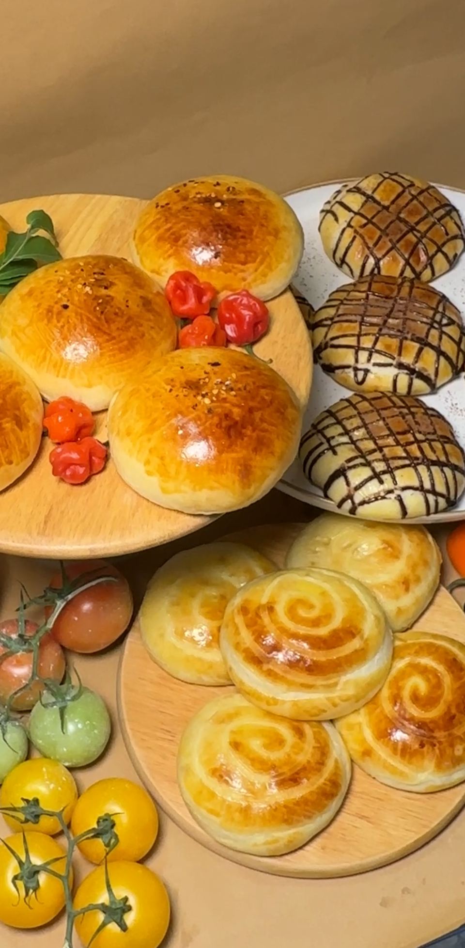 Tuna buns with chillies, chocolate buns and cream buns on wooden boards