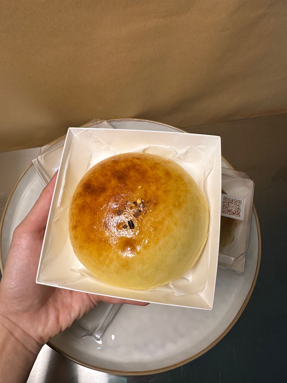 A glazed tuna bun in its clear box