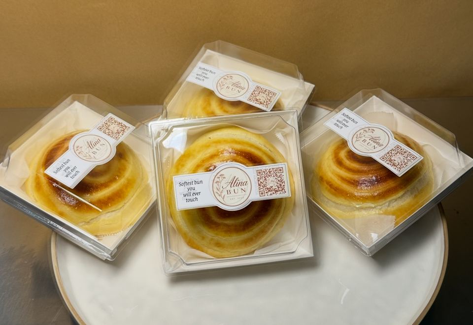 Three boxed cream buns