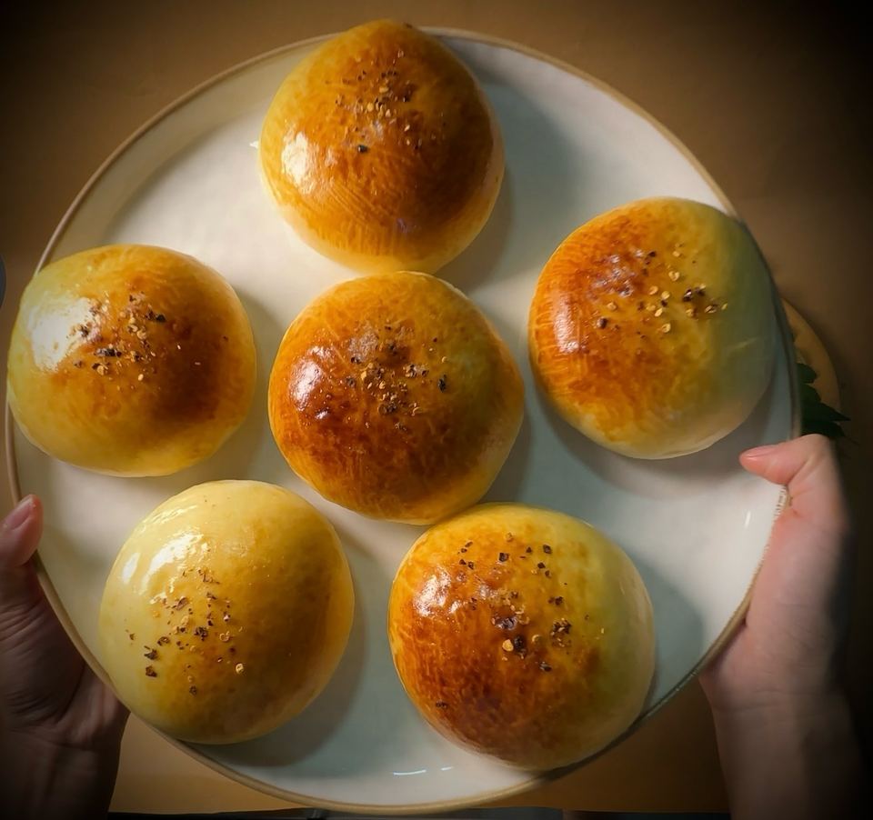 Round golden buns on a plate