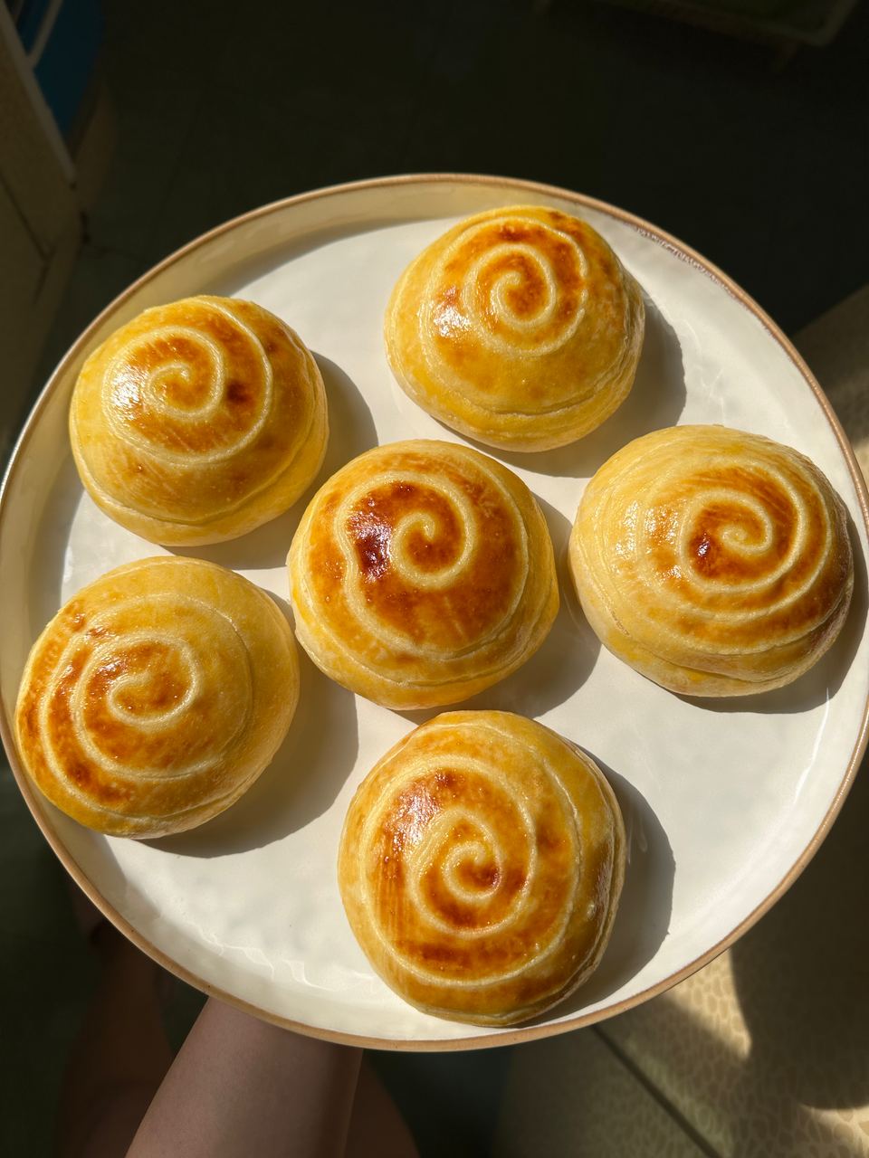 A plate of swirled cream buns