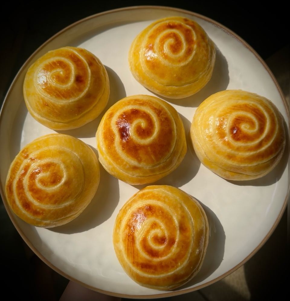 Swirled cream buns from above, in the sun