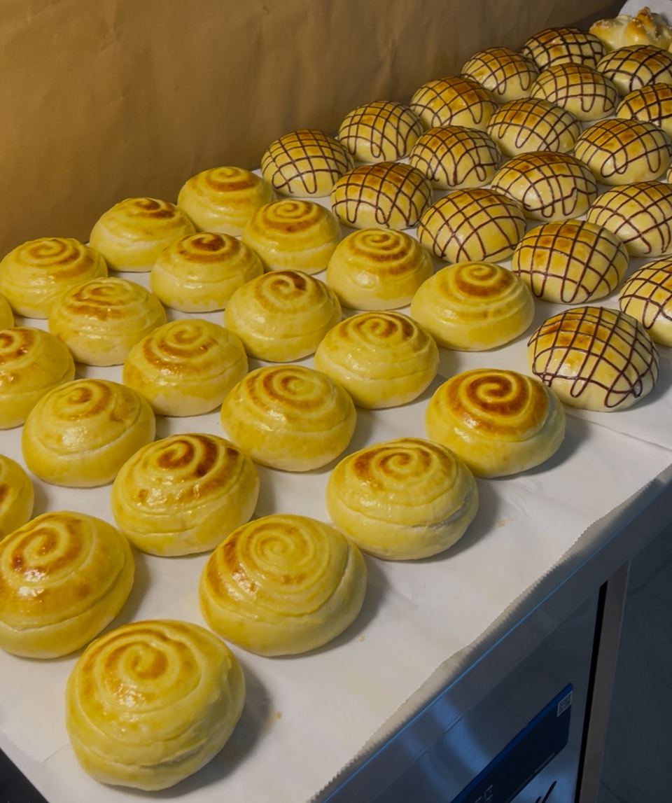 Trays of glazed buns ready for the oven